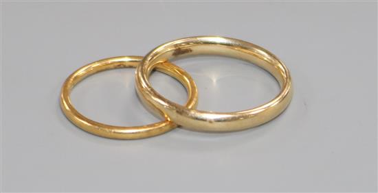 A 22ct. gold wedding band and a 9ct gold wedding band.